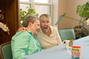 two-residents-hugging-half-size